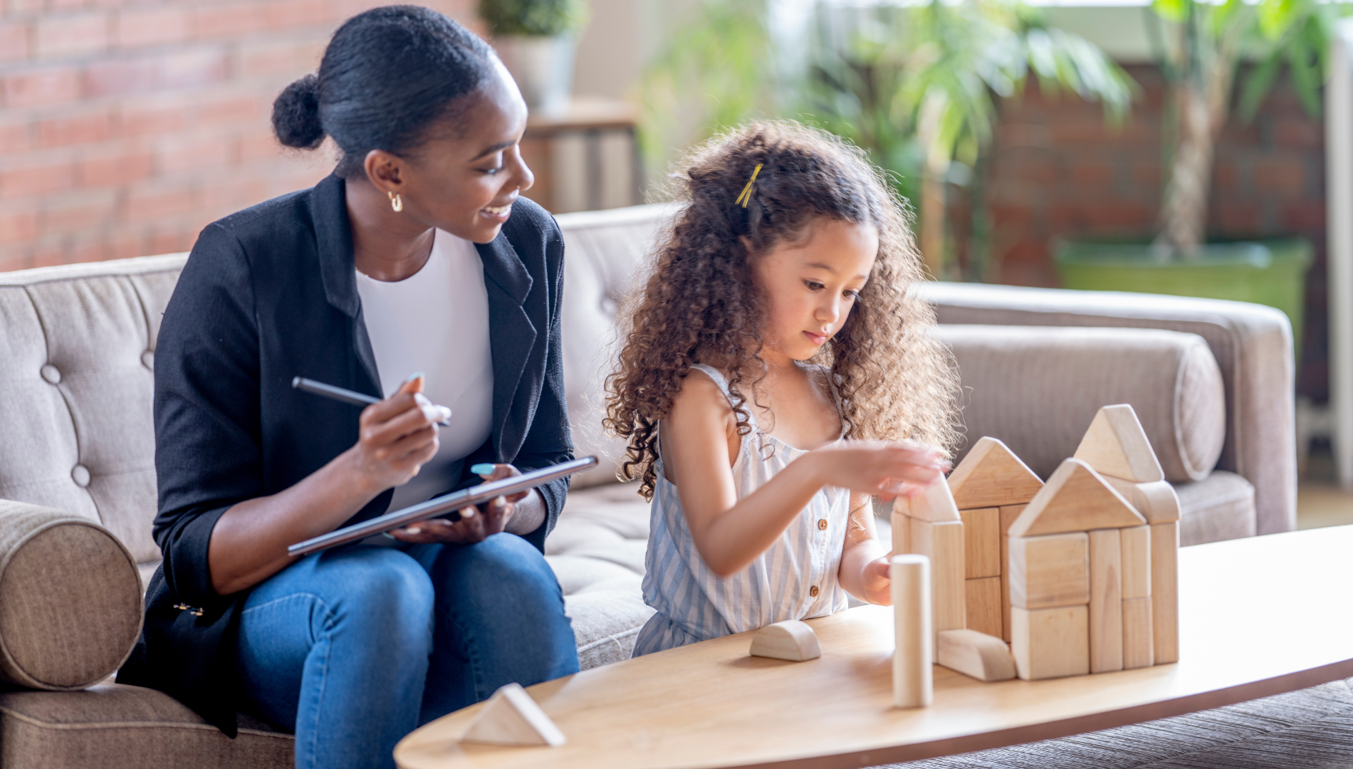 ABA therapy near me showing a therapist supporting a child during a structured play-based learning activity